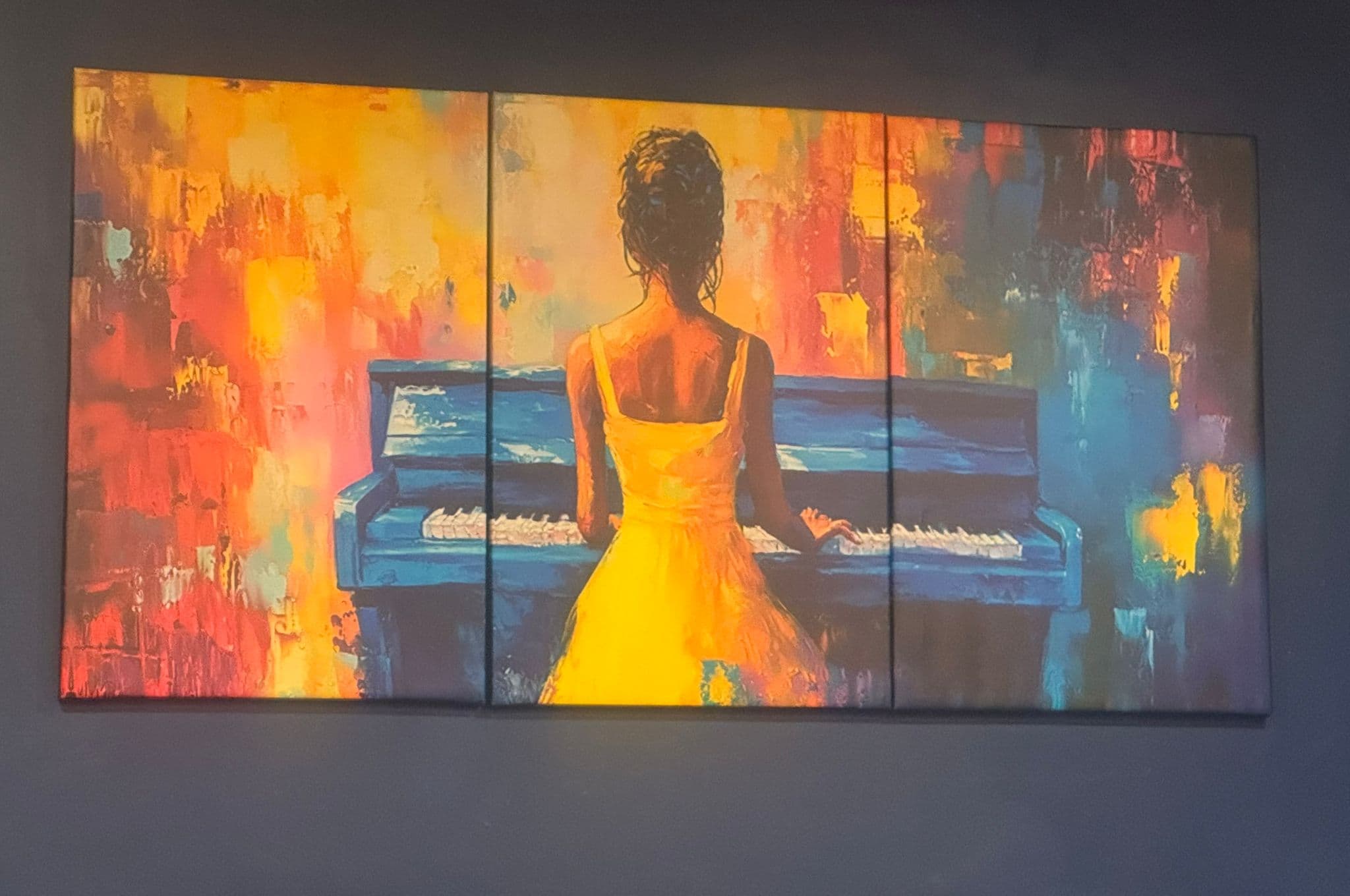 The painting of a woman at a piano in the Black Ivory room