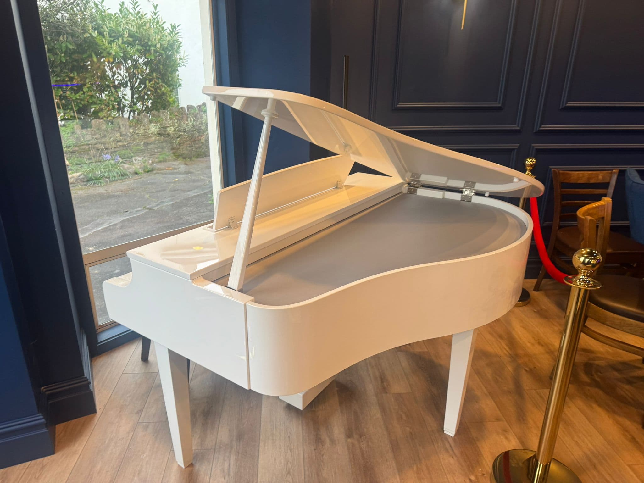 The white grand piano in the window of Black Ivory Piano Bar, Paignton